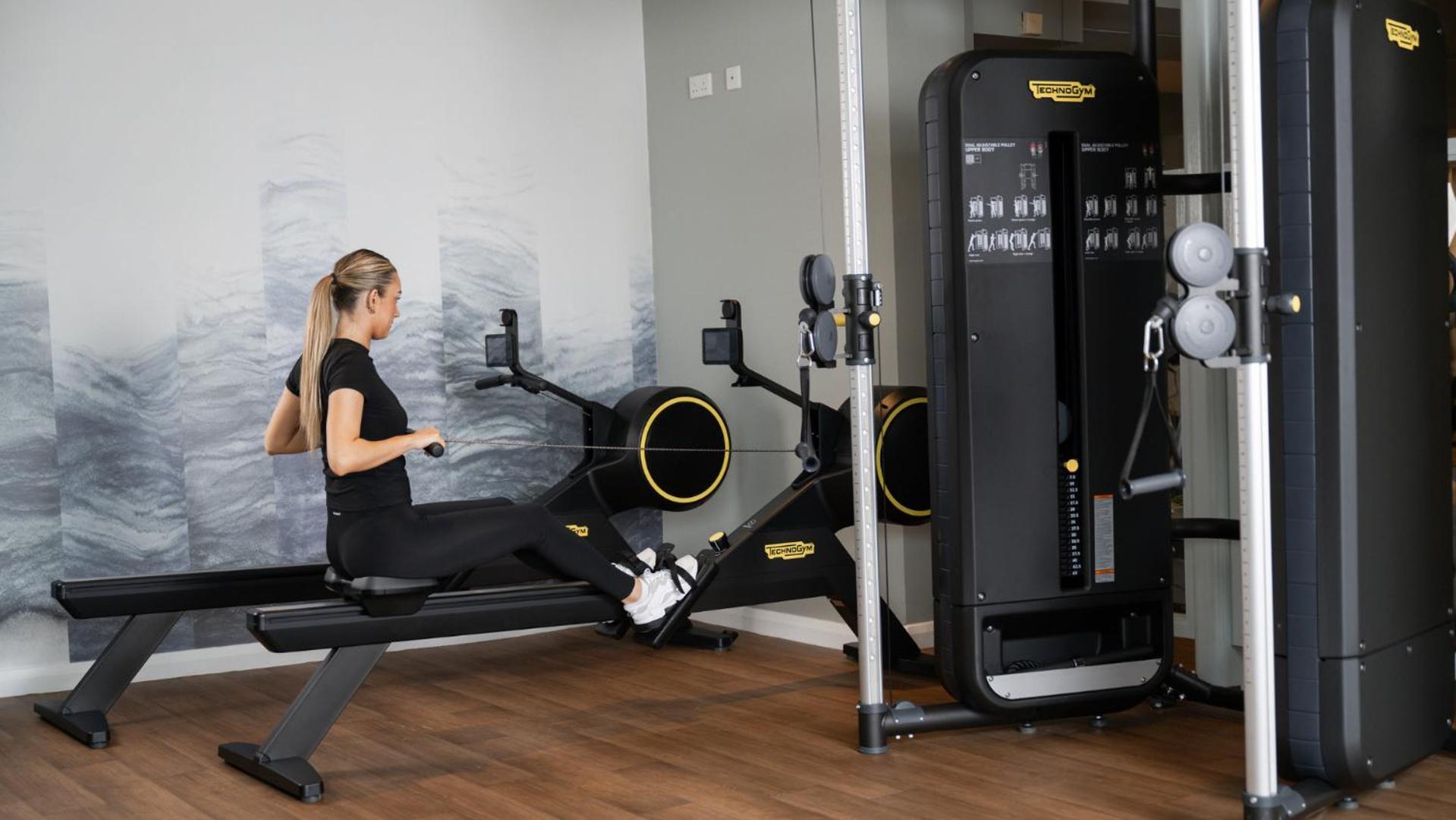 The Culloden Estate And Spa Холивуд Екстериор снимка A woman using a rowing machine