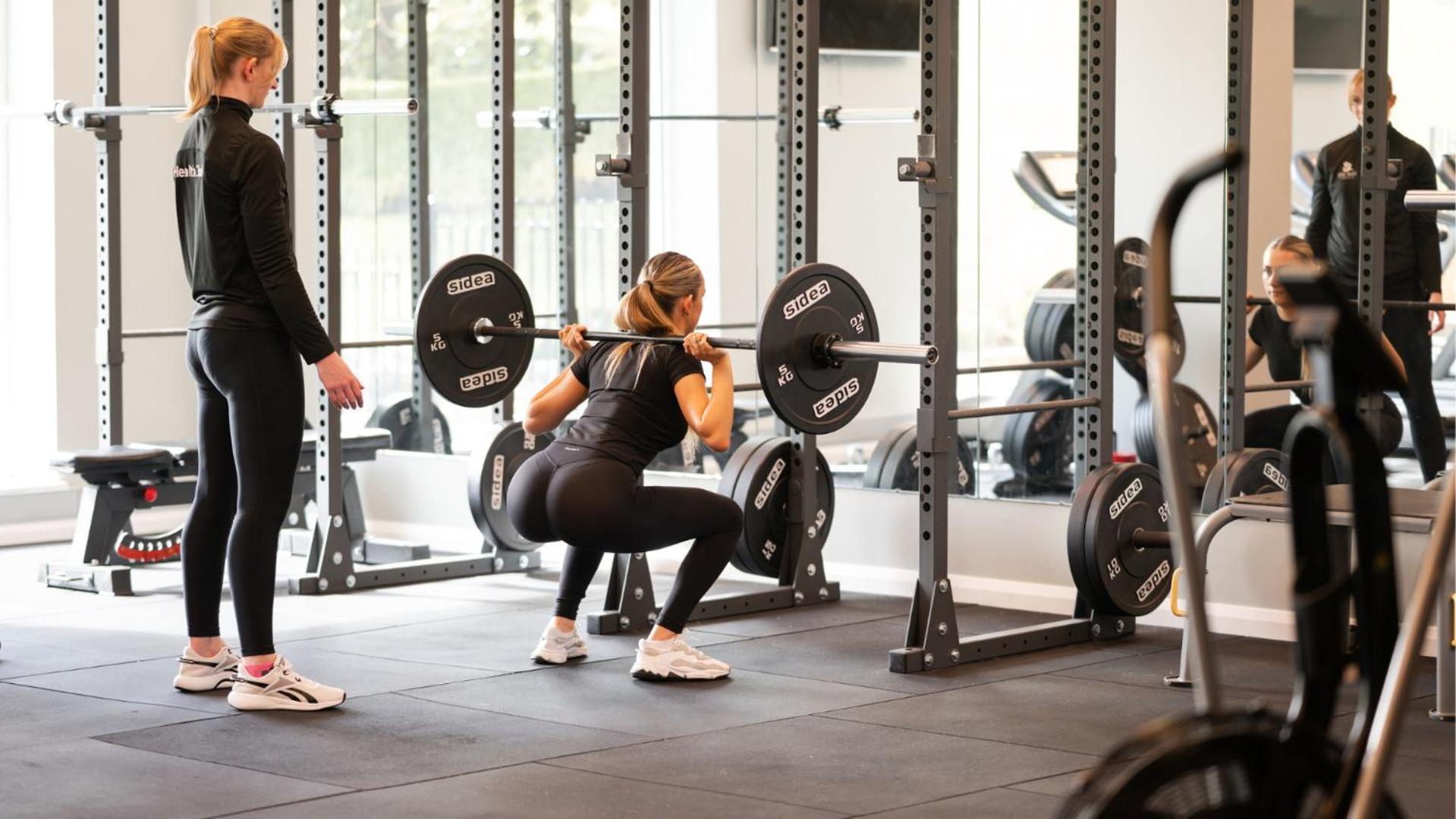The Culloden Estate And Spa Холивуд Екстериор снимка A woman performing a back squat with a barbell